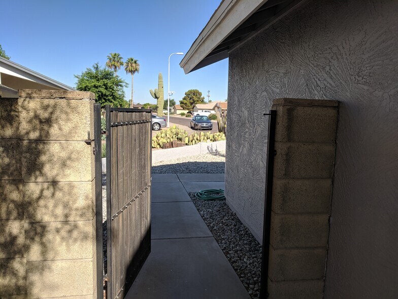 South wall of home and gate to front yard. - 14101 N 78th Dr