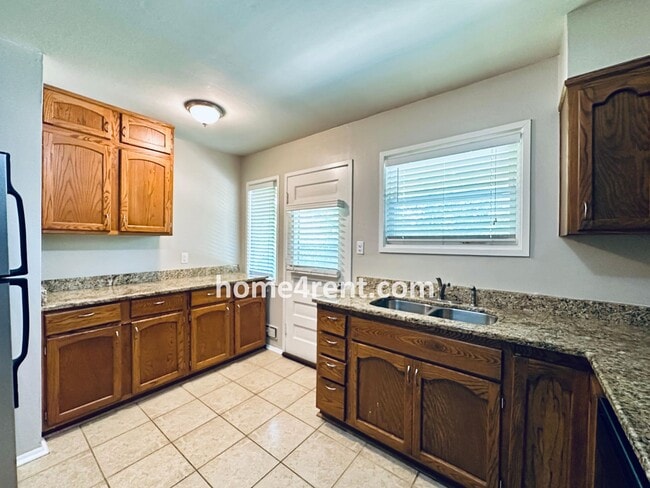 Building Photo - Attractive Prairie Village Ranch w/ FRESH PAINT, Wood Floors, Granite Counters and a Fenced Yard!