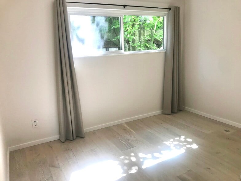 Wake up to morning light filtering through the maple tree in the East bedroom - 4253 Palatine Ave N