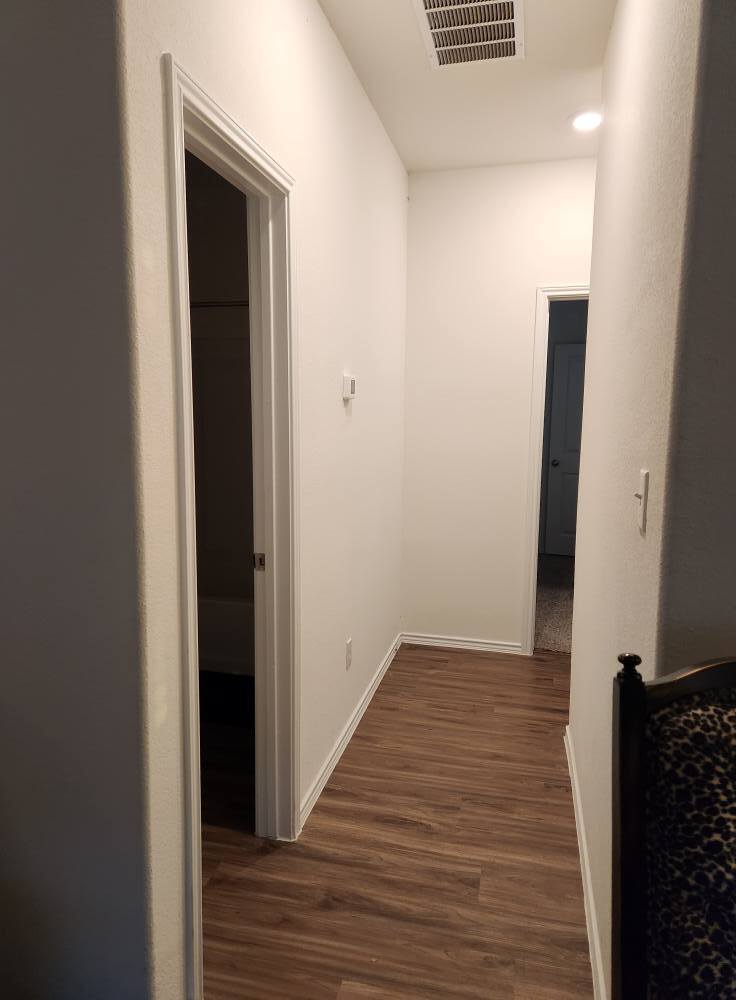 Second hallway leading to guest bath, guest bedroom, and main bedroom. - 13306 Mussel Run