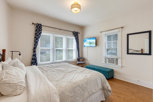 Large downstairs bedroom with king size bed, closet and flat screen TV. - 717 E Lakeside Ave