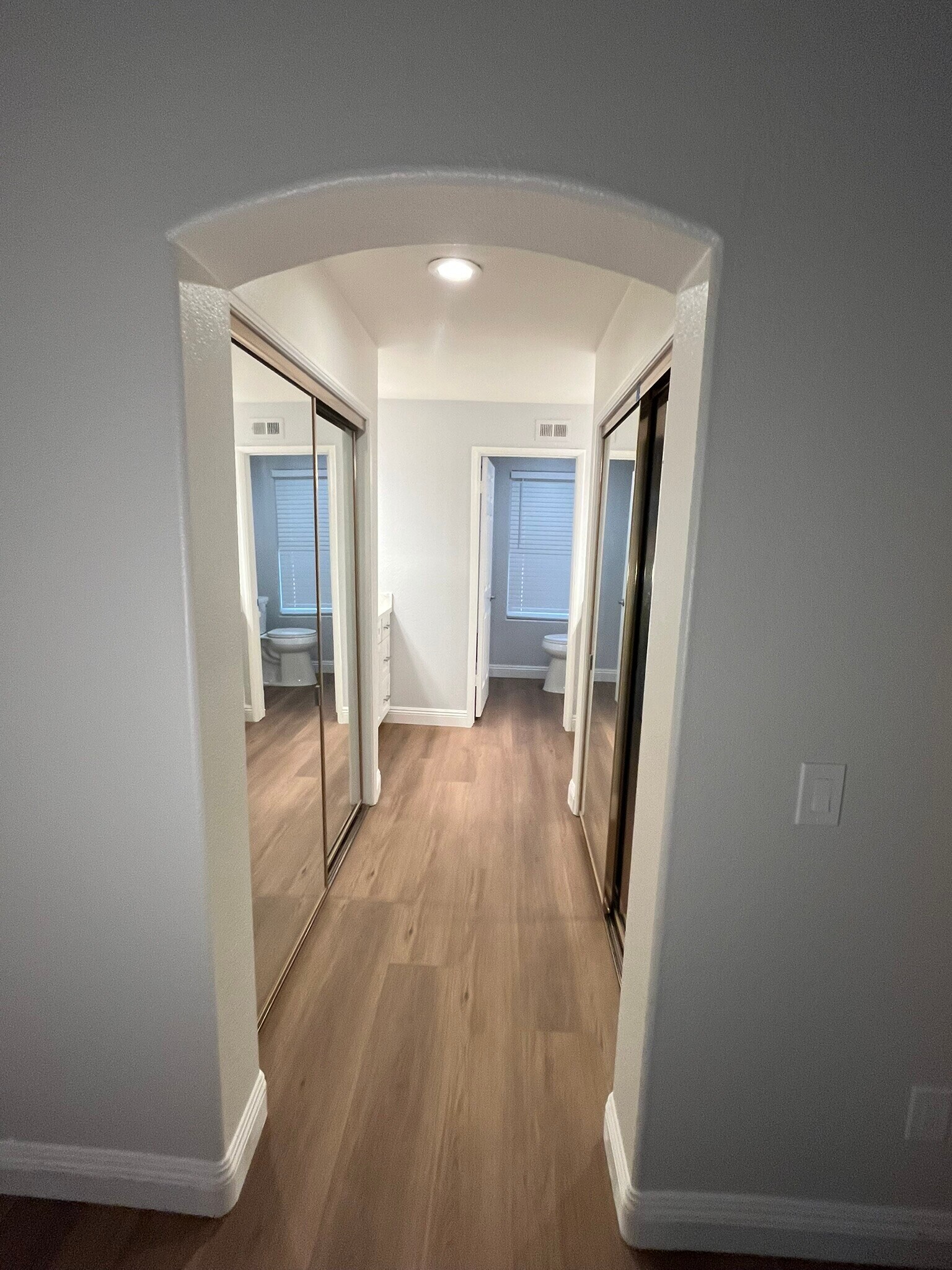 Master bedroom hallway with mirrored his/her closets leadng to bath with 2 vanities - 16274 Avenida Venusto