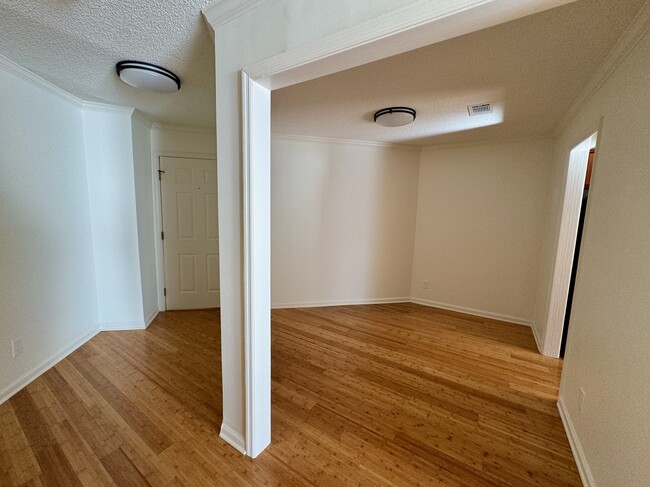 front entry hall and door at left, office/bonus room at right - 209 14th St. NE #119