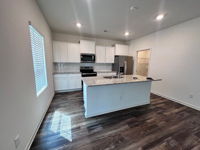 Building Photo - efficient two-level home provides a large living room, 4 very spacious bedrooms, and 2.5 bathrooms