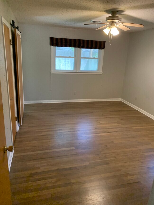 Master bedroom with barn door for the bathroom and there are two closets, Hardwood refinished 8/2023 - 4308 Olsen Blvd