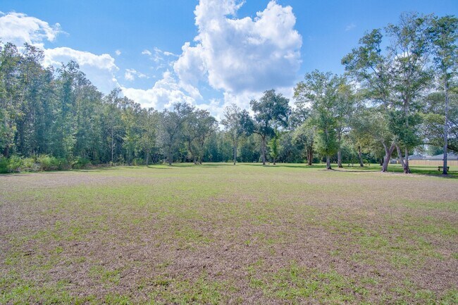 Building Photo - 4-Bed, 2-Bath Home in Woodlands Subdivision with Solar, Open-Concept Living, Modern Kitchen, Fenc...