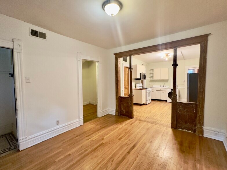 living room, kitchen beyond, door to left of woodwork leads to iffce - 2640 West Thomas Street