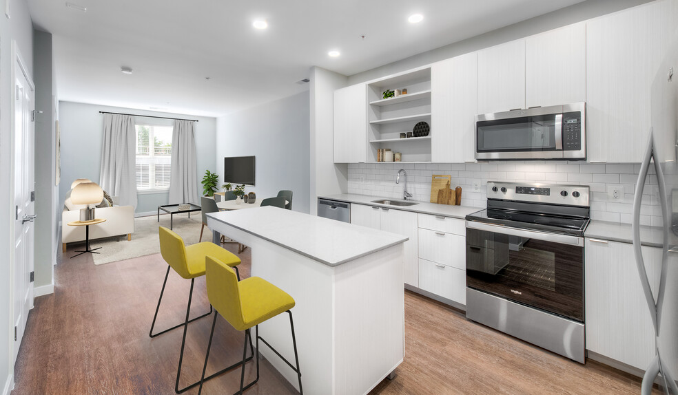 Kitchen with quartz stone countertops and white cabinetry with tile backsplash on hard surface flooring - Kanso Twinbrook