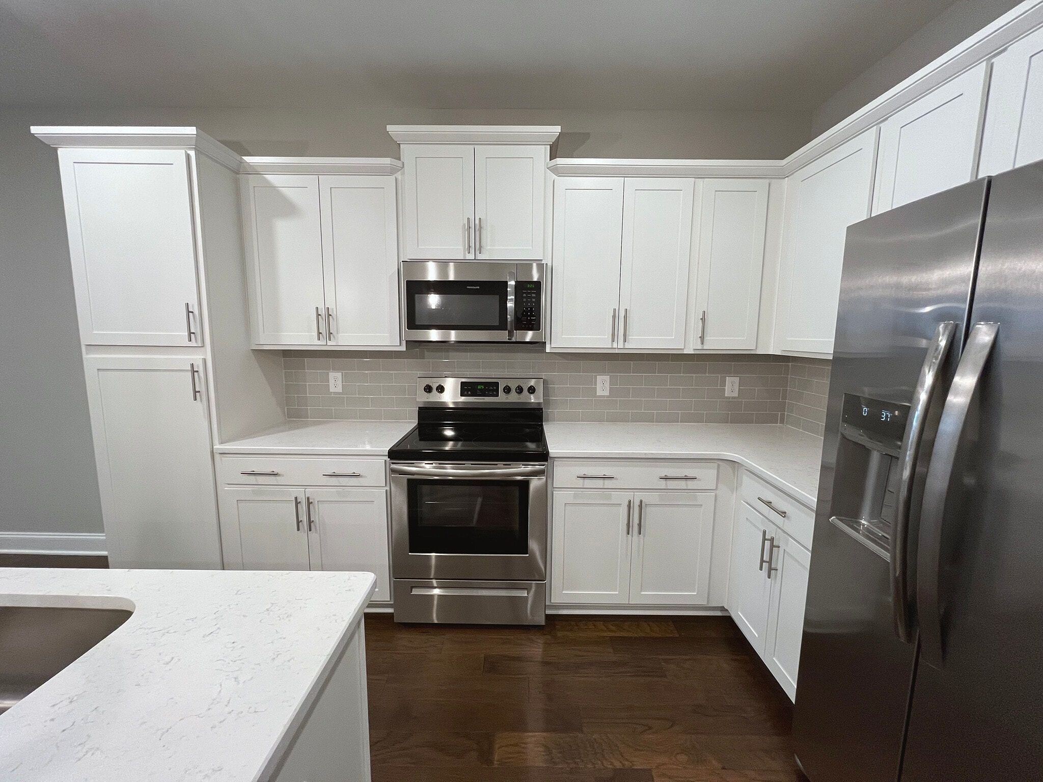 Cabinet area with Stove, Microwave and Fridge - 4000 Shadow Green Dr