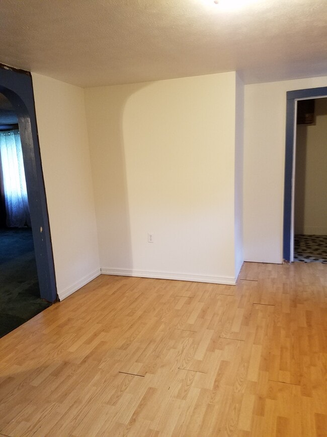 Kitchen, south wall with entry to Livingroom to the left and entry to Bathroom to the right. - 15 Goodrich St