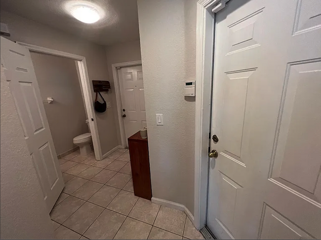 front entry way, first floor half bath and garage door - 1162 Imperial Lake Rd