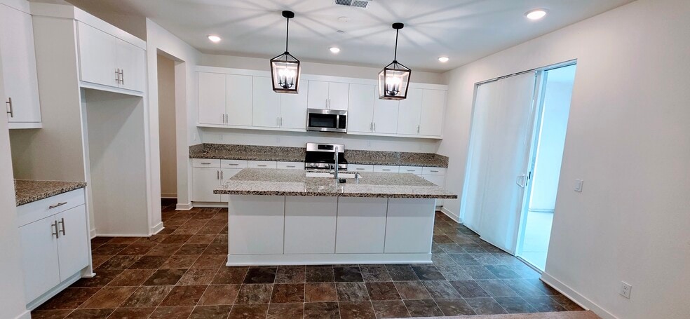 Kitchen is spacious with ample cabinets. Dishwasher is included. - 35147 Cooper Pl