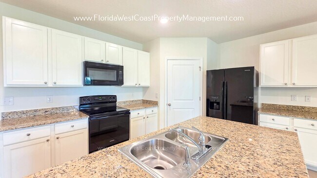 Building Photo - MOVE IN READY ! 4 BEDROOM/2 BATH! TILE- LVP THROUGHOUT! LAWN MOWING INCLUDED!