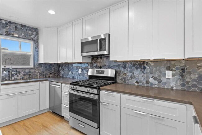 Building Photo - COMPLETELY REMODELED, BRIGHT & AIRY, TRI-LEVEL HOME W/ TOP-FLOOR GREAT ROOM LIVING SPACE, 2-CAR G...