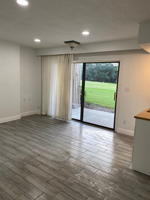 Main room with slider to private porch - 830 Pinewood Ct