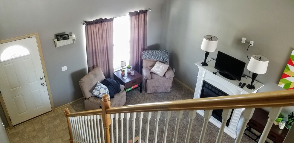 Spacious living room. View from the top of the stairs. - 6965 N 88th St