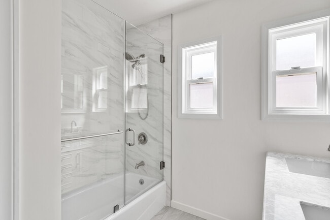 Brand new bathroom with glass enclosed show tub combo - 2451 22nd St