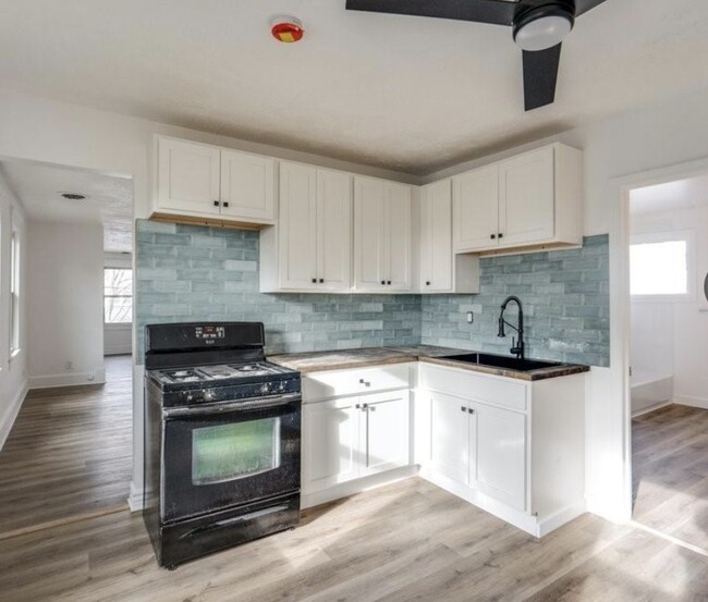 remodeled kitchen with butcher block countertops, new installed cabinets and sink - 3317 W 41st St