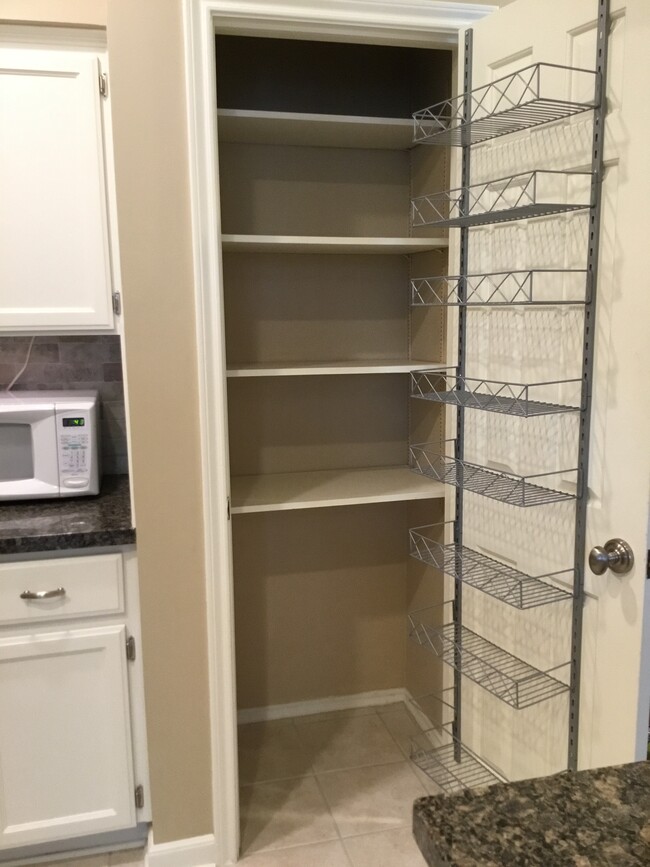 Deep pantry shelving with additional door rack storage - 1103 Dulles Ave