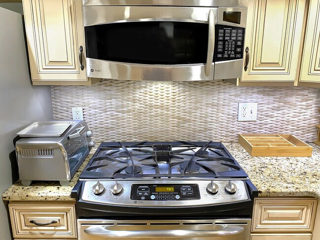 Kitchen area, stainless steel appliances, granite countertop, toaster oven. - 328 Garden St