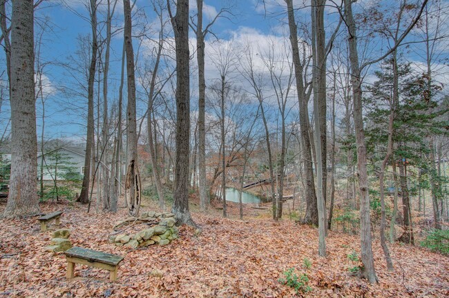 Building Photo - Nestled on a spacious, private wooded wate...