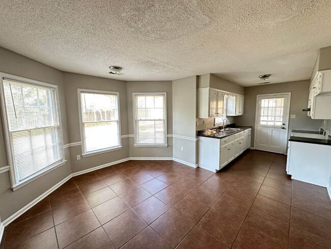 Building Photo - Charming 3BR/2BA Near Southwind | Hardwood Floors, Brick Fireplace, Bay Window & 2-Car Garage