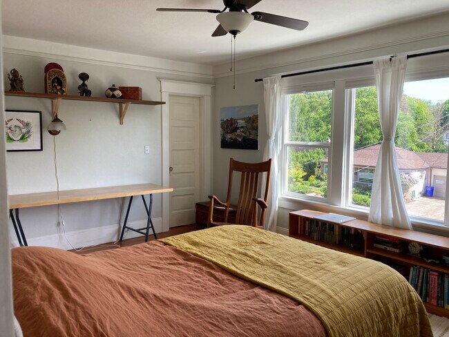 Primary bedroom with enormous south-facing windows. - 1405 NE Buffalo St