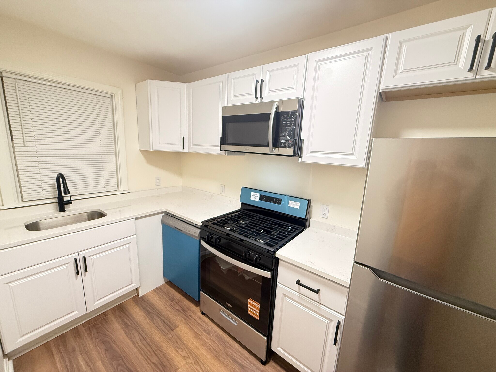 Kitchen with Quartz countertops and all new stainless steel appliances (not staged) - 72 Darling St