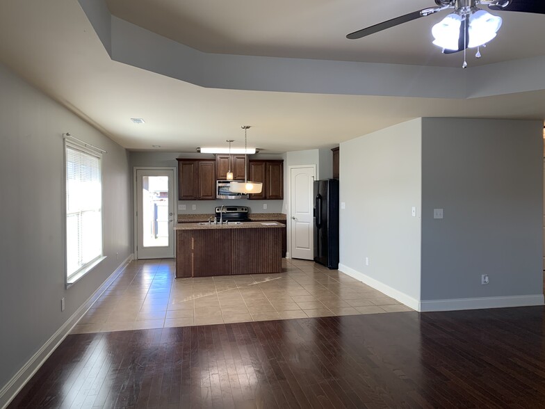 Stainless steel microwave and oven. View of the kitchen with included refrigerator - 253 Village Springs Dr