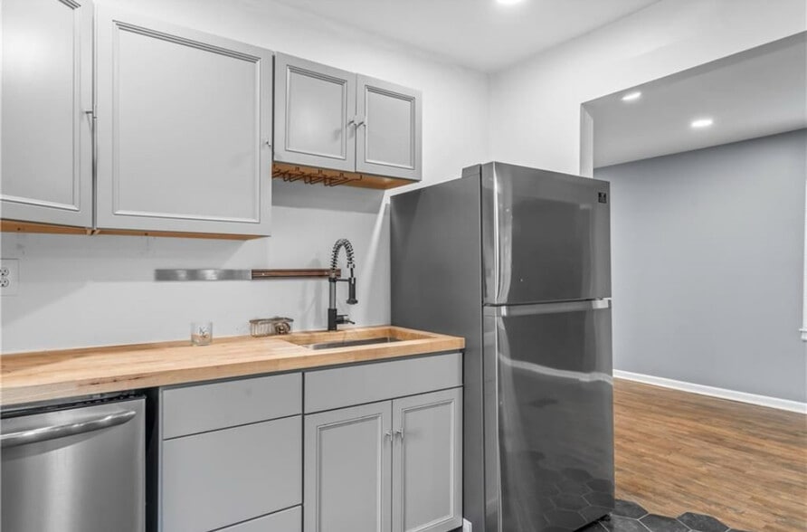 Butcher block counter top, large single basin brushed stainless sink with quality faucet. New fridge - 600 Ridgeview Ave