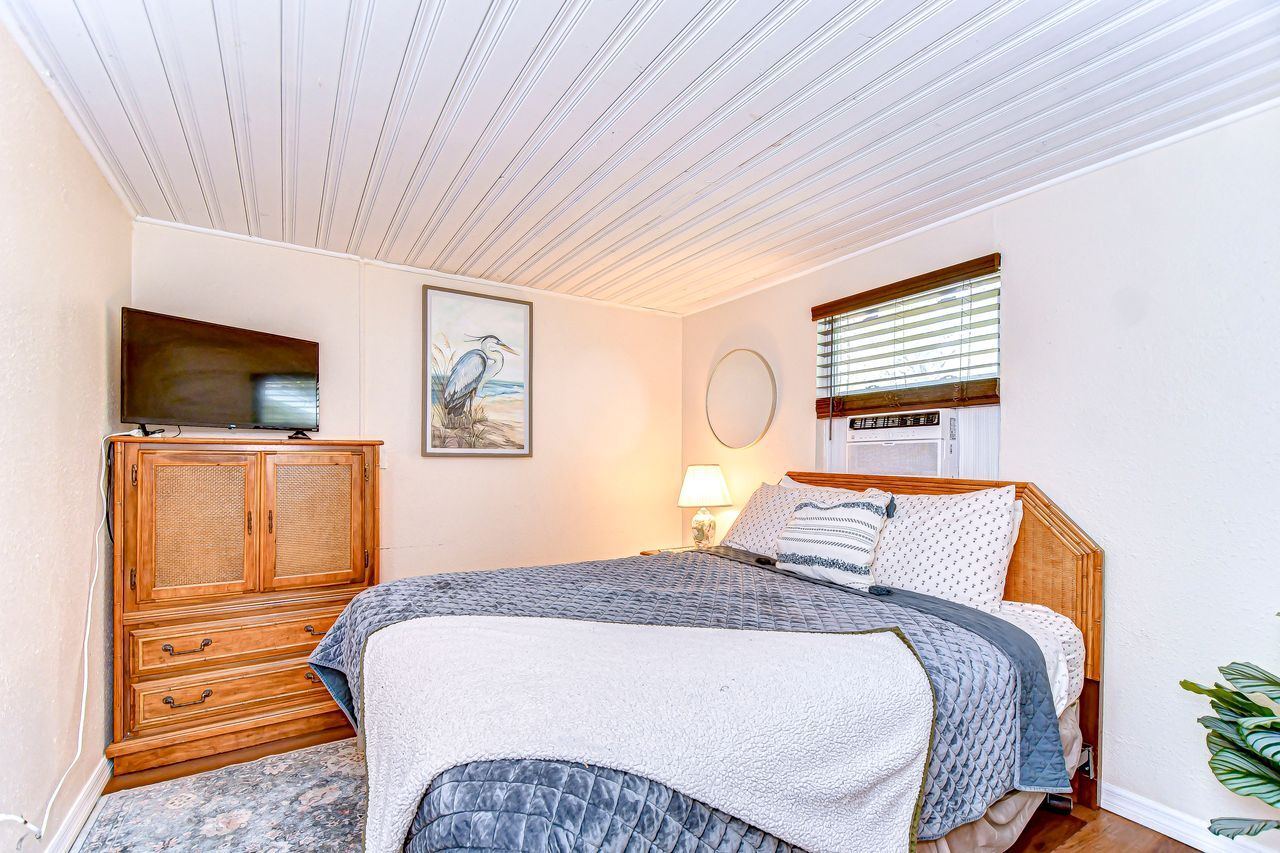 The bedroom features a queen bed with a 32" smart tv and large closet - 5114 33rd St E