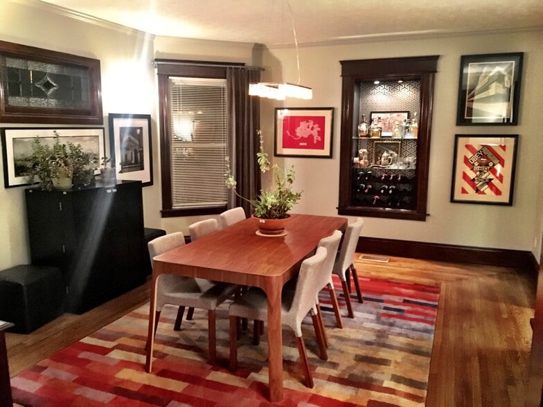Original wood floors highlight a beautiful dining room with a unique built in wine rack. - 565 Delta Avenue
