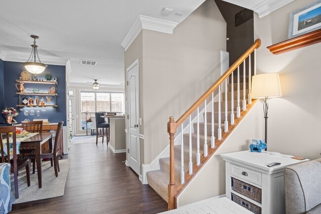 Building Photo - This inviting two-level townhome offers comfort and style, featuring gleaming hardwood floors on ...