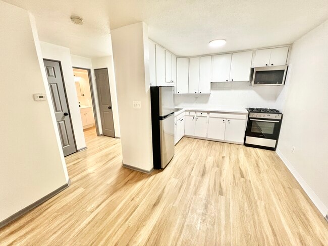 Explore this stylish kitchen with open connections to the home's other inviting spaces. - Melody Apartments