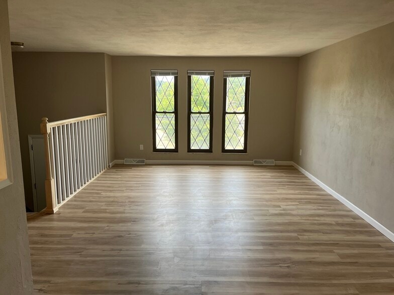Living Room with new flooring and fresh paint. - 608 Sangree Rd