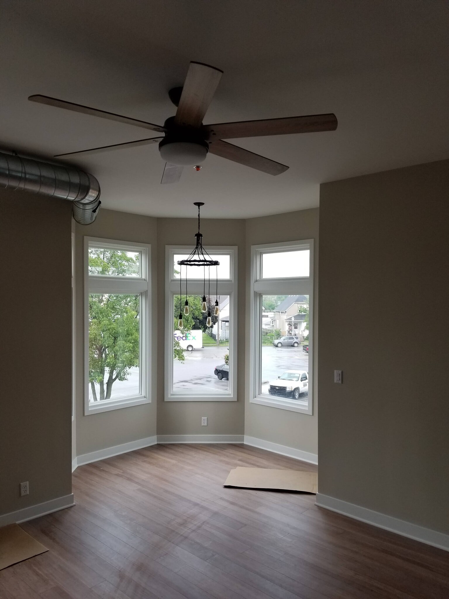 Dining area bumpout surrounded by windows with an industrial overhead light fixture - 1548 119th St