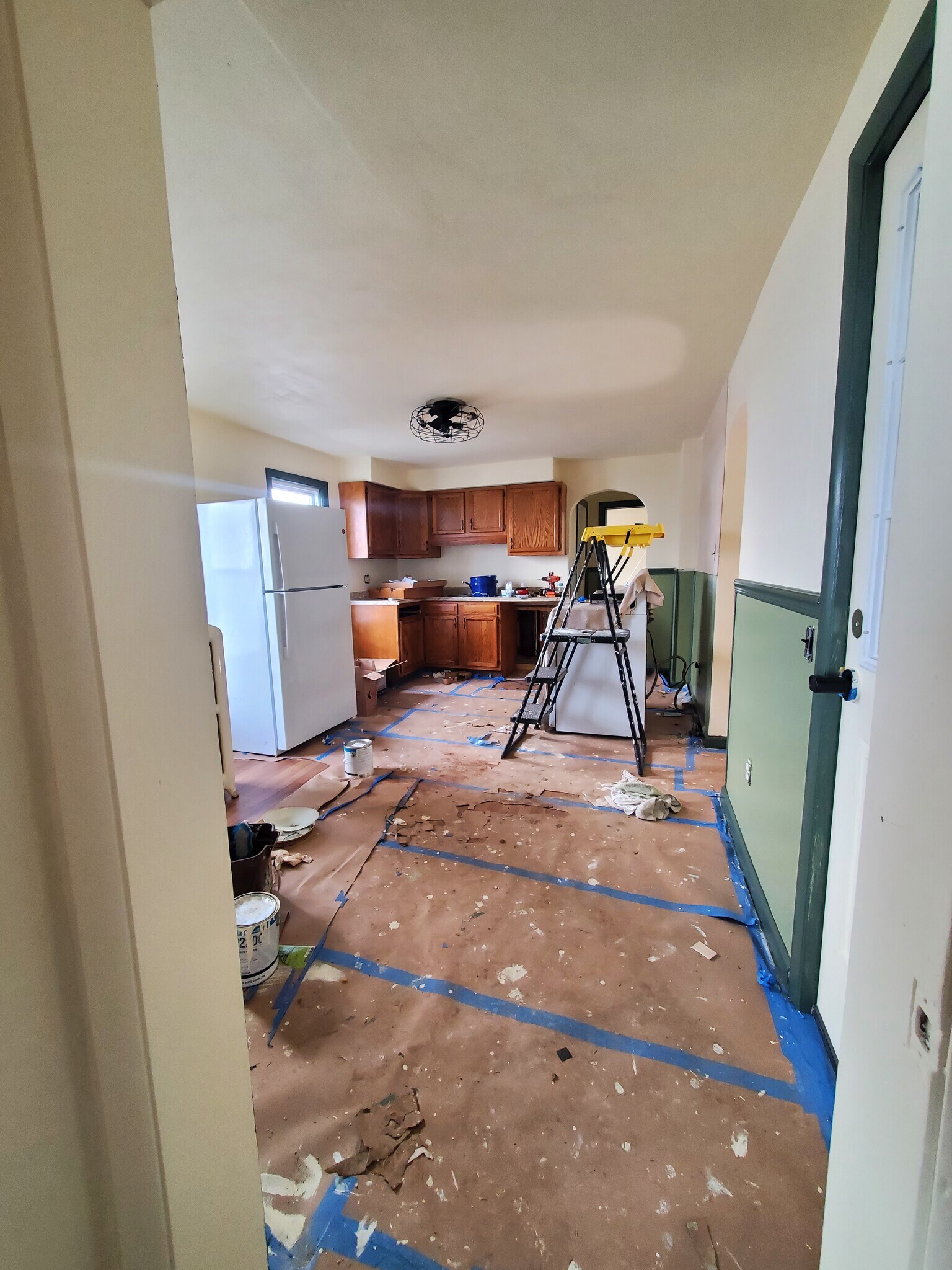 refurbished kitchen loading! Fresh paint, new fandelier, refinished wood cupboards - 321 Odell Ave