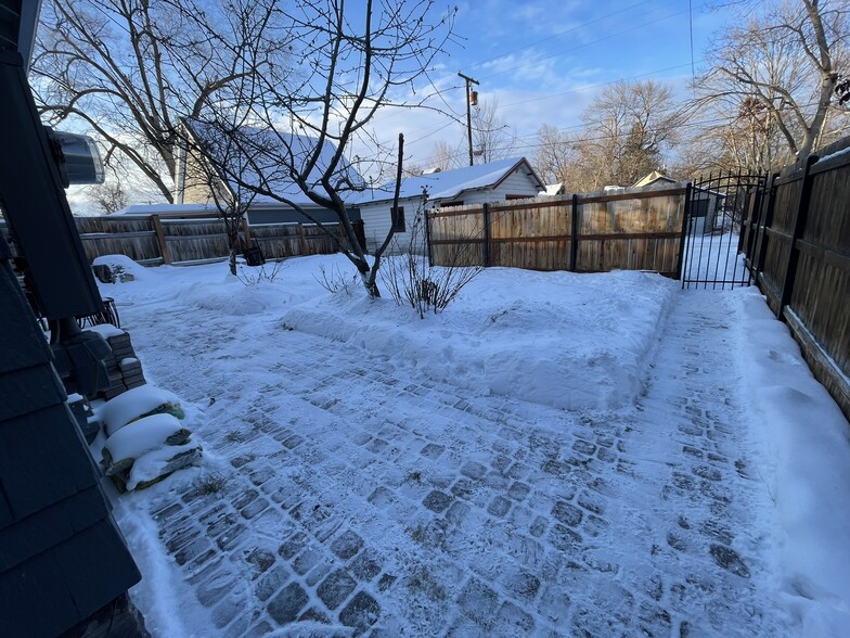 view of bakyard (winter) showing 10 foot wide paver patio and access to alley parking - 508 Daly Ave