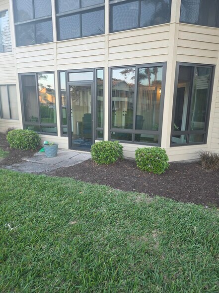 Rear Yard View back to Enclosed Lanai - 113 Golden Eye Dr