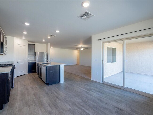 Building Photo - Spacious 4-Bedroom Home with Open Layout & Turf Backyard