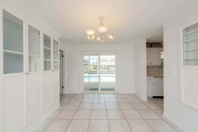 Building Photo - Live the ultimate Space Coast waterfront lifestyle at this stunning beachside canal home in Satel...