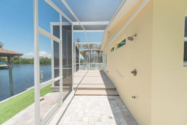 Building Photo - Live the ultimate Space Coast waterfront lifestyle at this stunning beachside canal home in Satel...