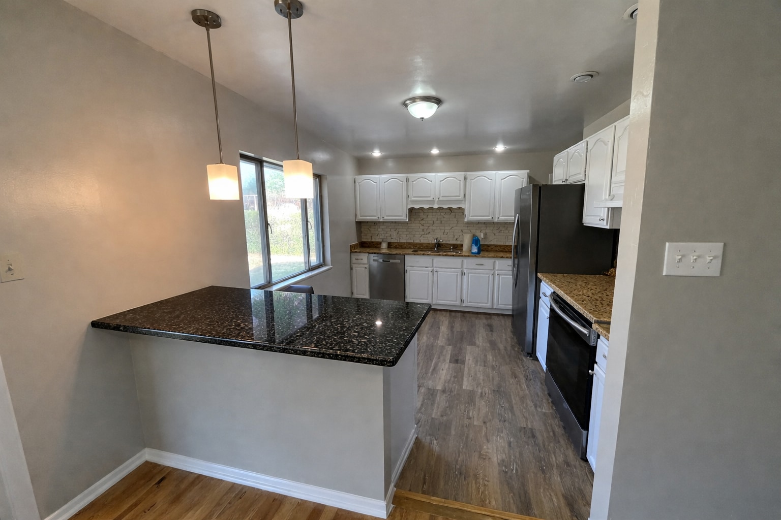 Remodeled kitchen opened up to dining room with granite countertops - 7991 E Hampden Cir