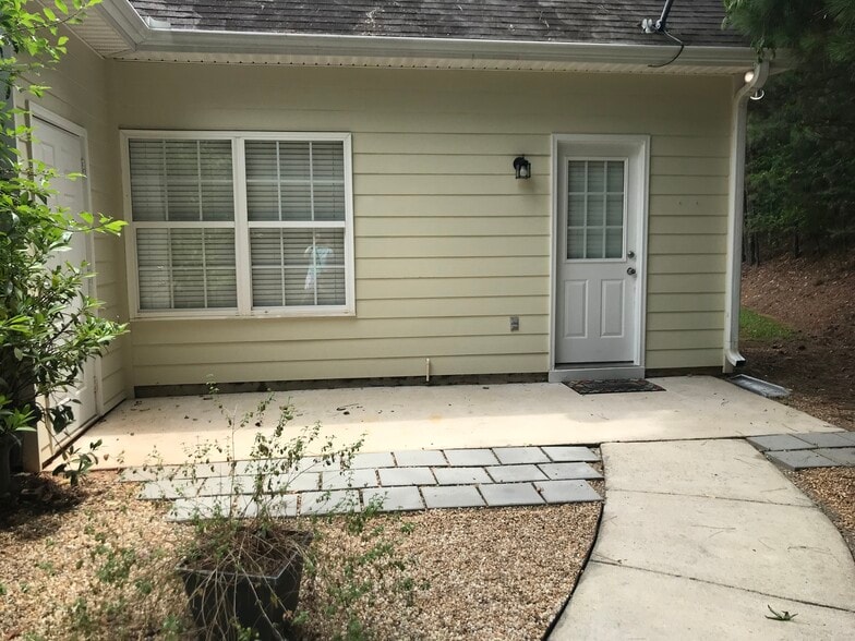 Back patio has access to unit dedicated parking area, outside storage room and a large patio great for grilling! - 1305 Cedar Shoals Drive #500
