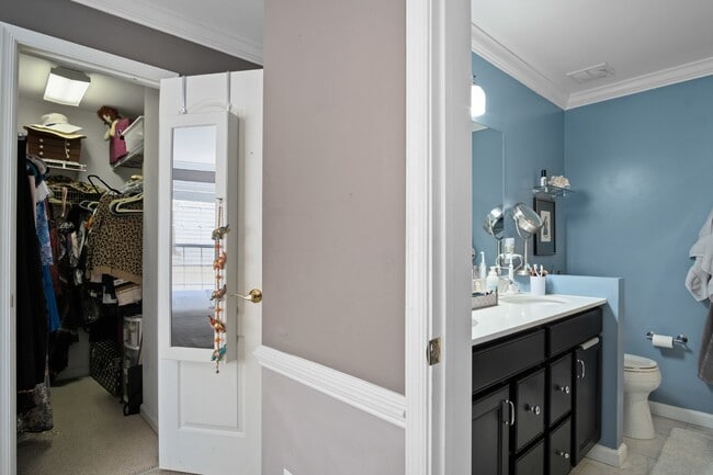 Building Photo - This inviting two-level townhome offers comfort and style, featuring gleaming hardwood floors on ...