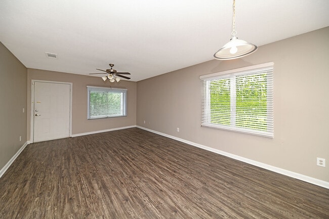 Spacious living room with hardwood-style flooring - Prairie Creek Estates