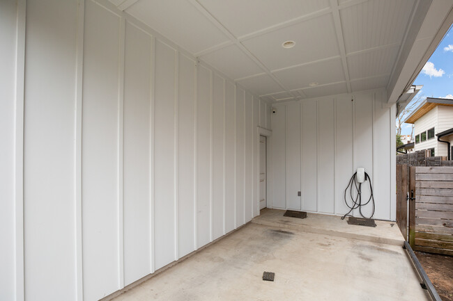 Carport with Tesla charger. - 1003 Cardinal Ln