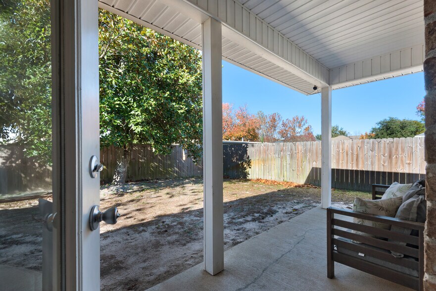 Backyard has a private fence, patio furniture, and barbecue - 28 Snook Rd