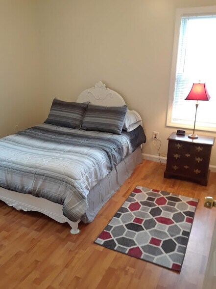 Bedroom 1 with full size bed. - 56 Fulton St