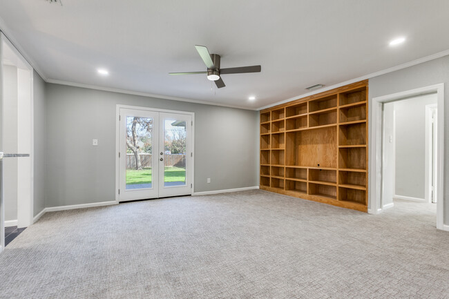 French doors out to deck and back yard. Built in book case. - 8738 Glencrest Ln